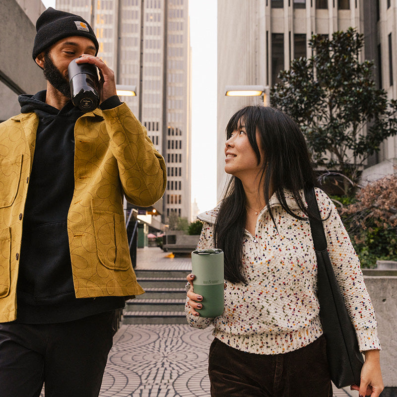 16oz-rise-tumbler-p4 16oz_rise_tumbler_black_iceberg_couple_drink_city_street_square.jpg