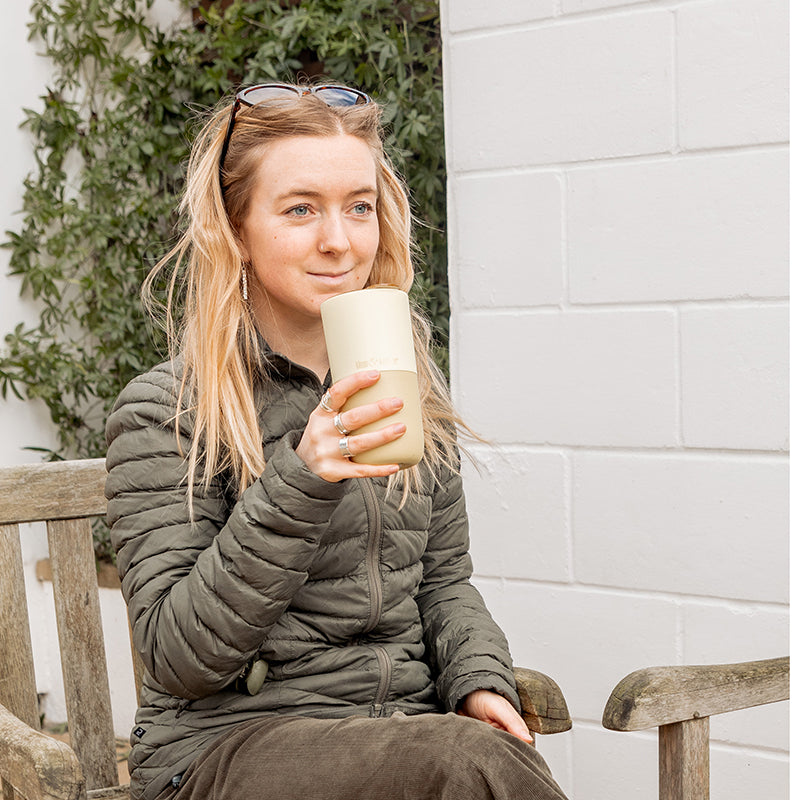 16oz-rise-tumbler-p4 16oz_rise_tumbler_wax_yellow_woman_seat_outside_square.jpg