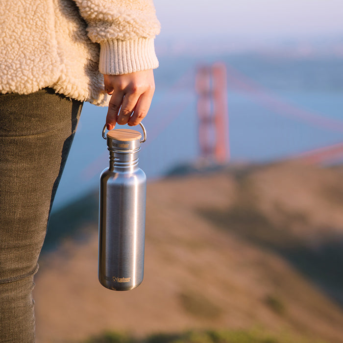 27oz-reflect-with-bamboo-cap-e7 K27SSLRF-BS-BAMBOO_reflect_bottle_bridge_lifestyle.jpg