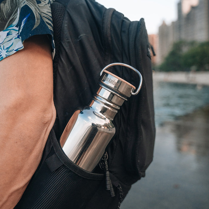 27oz-reflect-with-bamboo-cap-e7 K27SSLRF-MS-BAMBOO_reflect-bottle_backpack_lifestyle.jpg